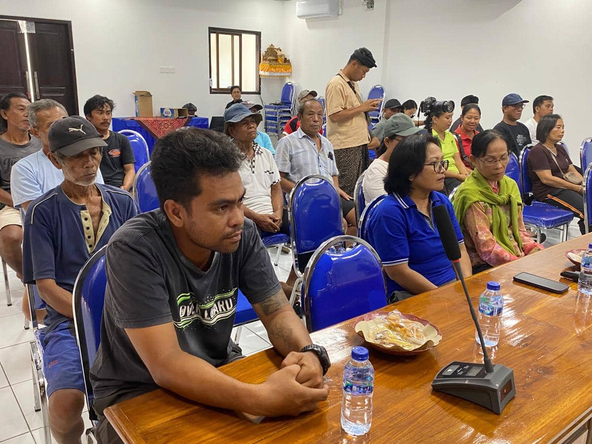 Sejumlah warga terdampak abrasi Pantai Mongalan duduk di ruang pertemuan, mendengarkan penjelasan dengan serius di depan meja kayu.