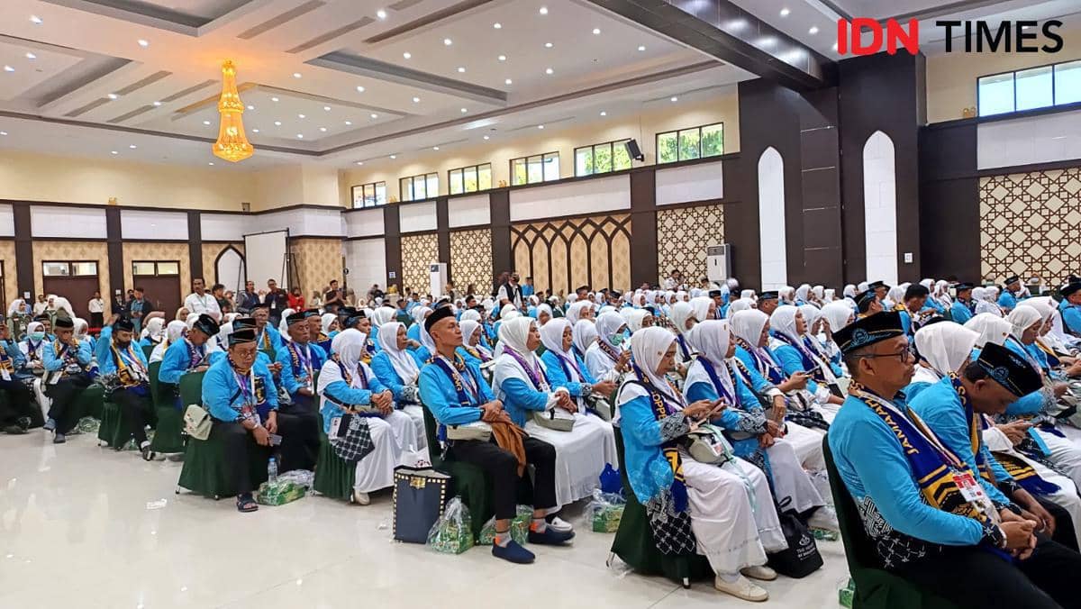 Jemaah haji kloter pertama Embarkasi Makassar mengenakan seragam biru duduk di Aula Arafah Asrama Haji Sudiang saat prosesi pelepasan.