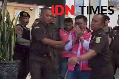 Ketua DPRD Magetan, Suratno bersama 5 orang tersangka lainnya saat di masukkan ke mobil tahanan. IDN Times/Riyanto.