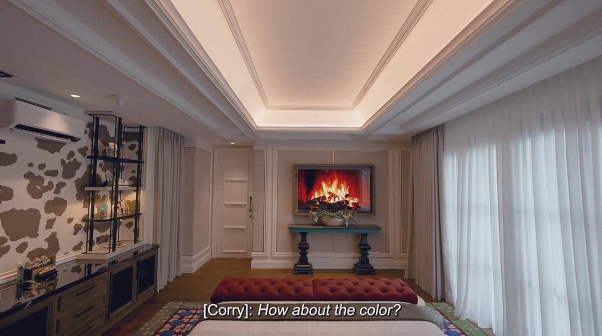 Kamar tidur mewah dengan desain elegan, menampilkan televisi dengan gambar perapian, pencahayaan lembut, dan tirai panjang berwarna putih.