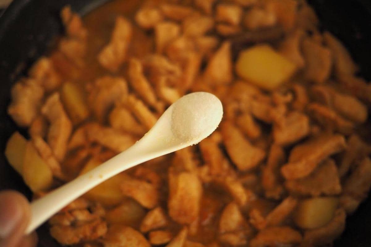 ilustrasi memasukkan gula ke masakan 