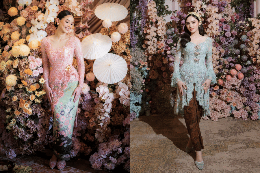 Dua wanita mengenakan kebaya modern berwarna pastel dengan latar dekorasi bunga berwarna lembut dalam acara pernikahan.