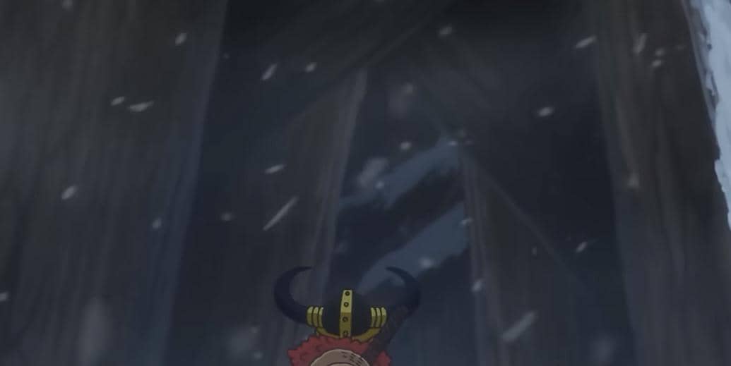 Luffy berdiri di depan lorong raksasa bersalju dengan latar gelap dan serpihan salju yang beterbangan di udara.