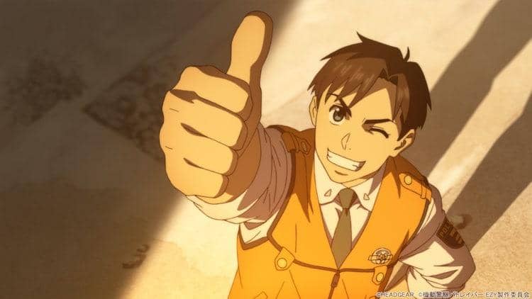 Karakter anime pria mengenakan seragam oranye memberikan acungan jempol sambil tersenyum dan mengedipkan mata dalam adegan Kidou Keisatsu Patlabor: EZY.