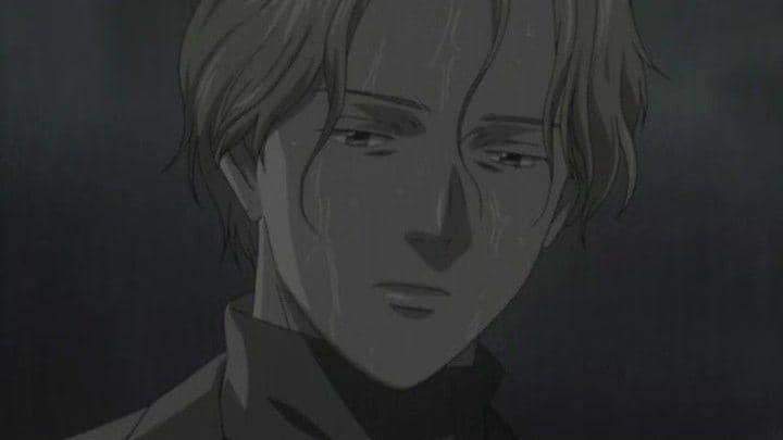 Johan Liebert dari anime Monster berdiri dalam suasana gelap dengan wajah basah oleh air hujan dan ekspresi datar penuh emosi.