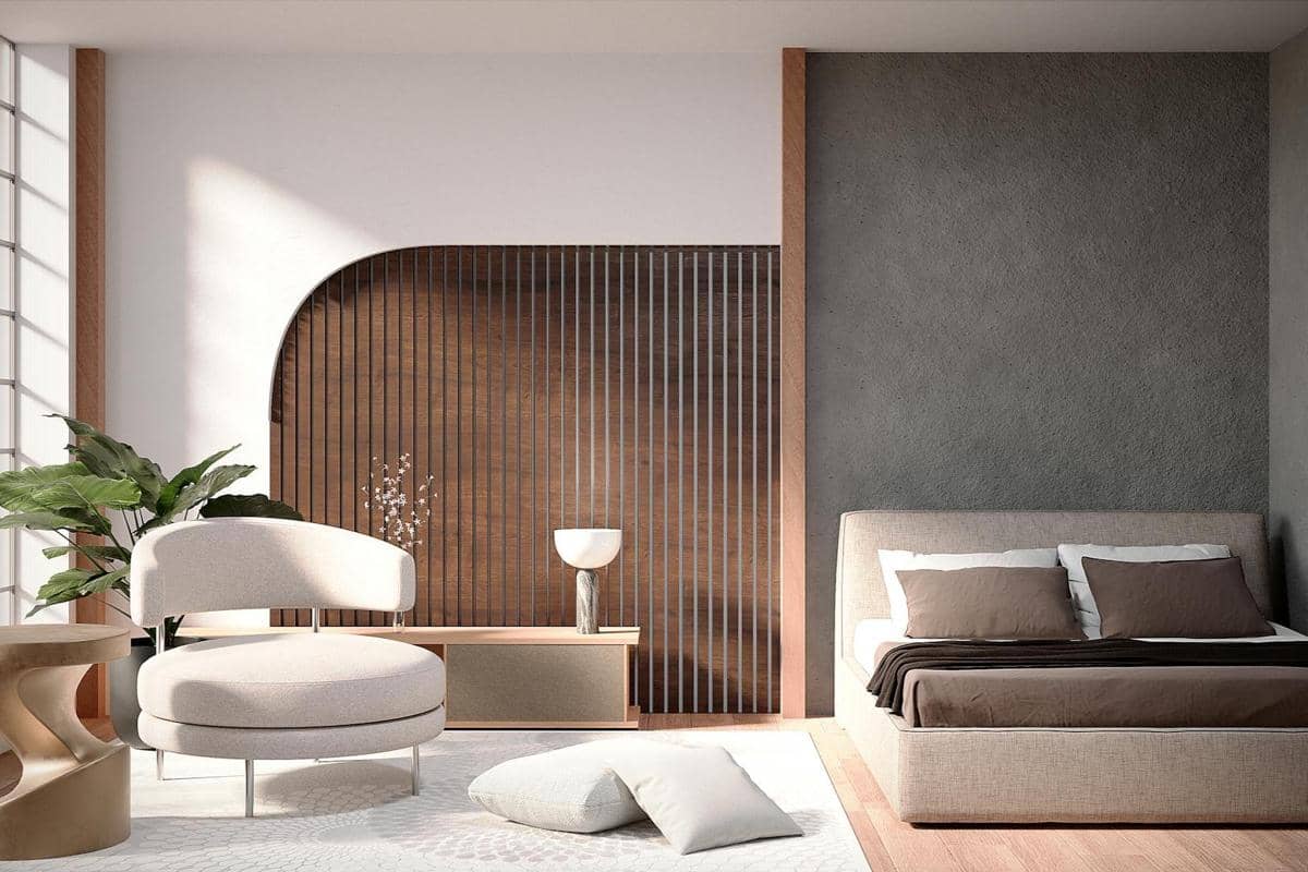 Kamar tidur modern dengan tempat tidur berwarna netral, kursi bundar, tanaman hias, dan dinding aksen kayu bergaya minimalis.