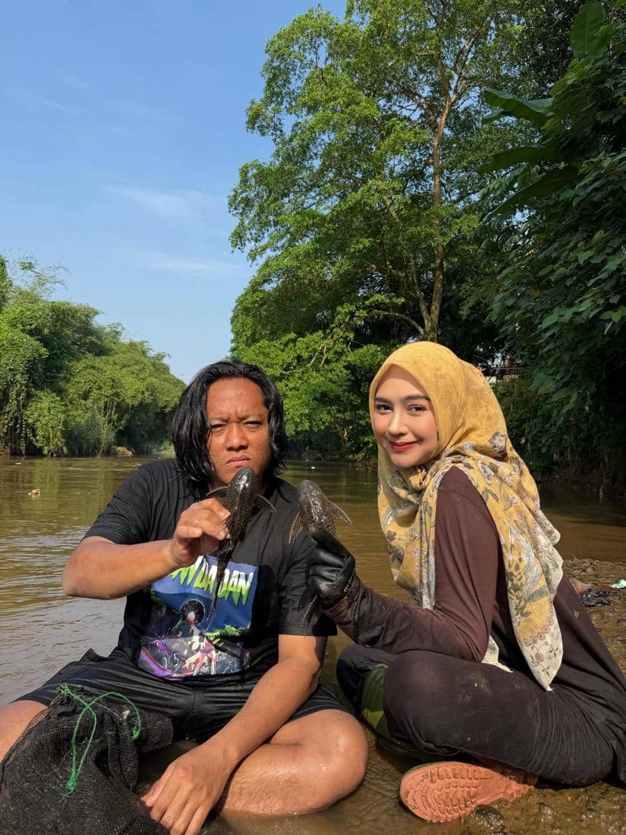 Ria Ricis menangkap ikan sapu-sapu di Sungai Ciliwung