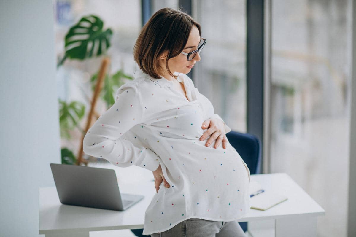 Ilustrasi perempuan hamil pada trimester ketiga dengan perut membesar, menggambarkan fase akhir masa kehamilan.