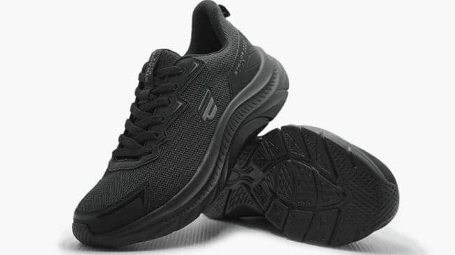 Sepasang sepatu olahraga warna hitam dengan desain modern dan sol tebal, menampilkan detail tekstur jaring dan tali hitam.