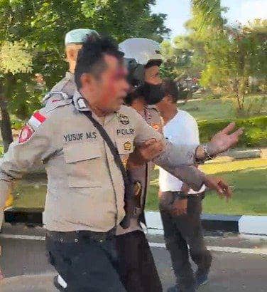 Seorang polisi mengalami luka di wajah saat diamankan rekan sesama petugas di area Kantor Gubernur NTT setelah aksi demo berlangsung.