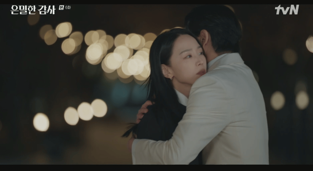 Dua karakter dalam drama Filing For Love berpelukan di malam hari dengan latar lampu bokeh yang hangat dan suasana emosional.