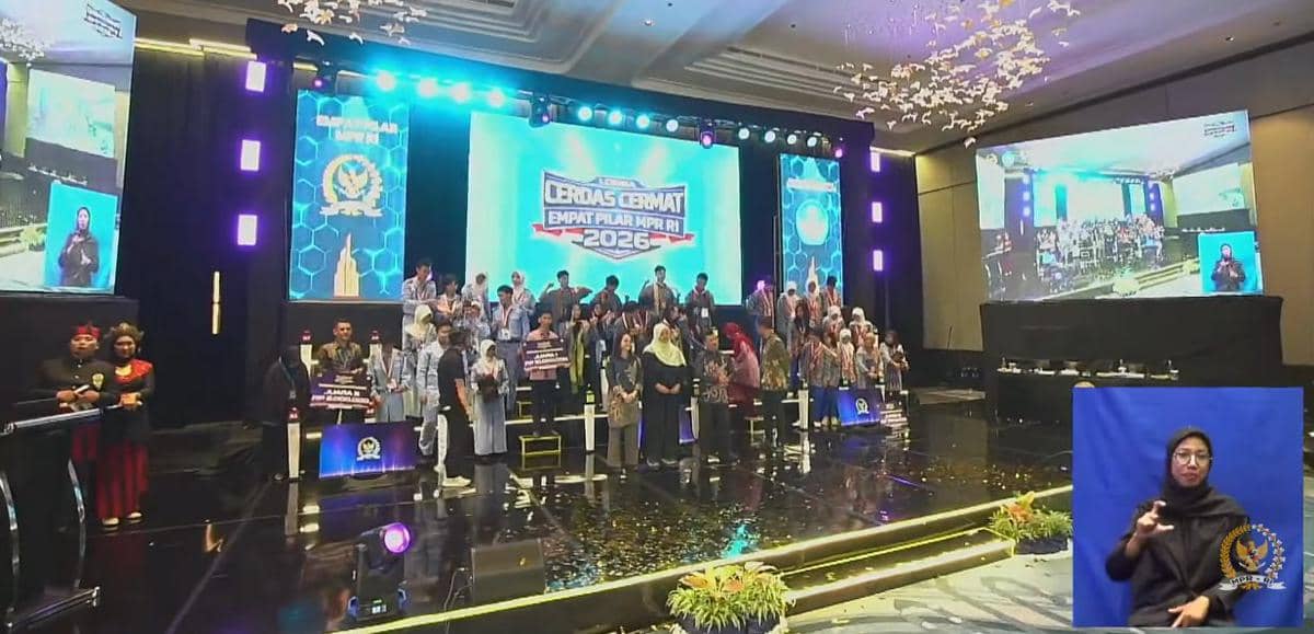 Para peserta dan panitia berdiri di atas panggung acara Lomba Cerdas Cermat Empat Pilar MPR RI 2026 dengan layar besar di latar belakang.