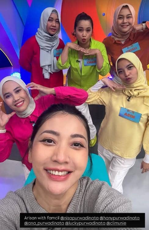 Enam perempuan berpose ceria di studio televisi dengan latar warna-warni saat mengikuti acara kuis arisan keluarga.