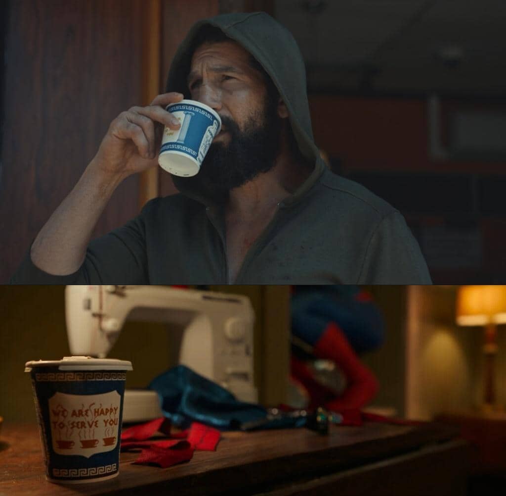 Seorang pria berjenggot mengenakan hoodie minum dari cangkir kertas, dan adegan lain memperlihatkan kostum Spider-Man di dekat mesin jahit.