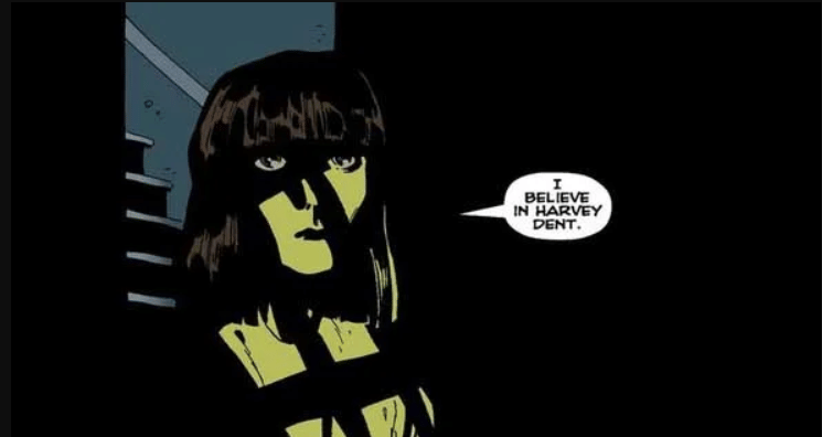 Ilustrasi karakter perempuan dari komik DC berdiri di tempat gelap dengan bayangan tegas dan teks balon dialog di sampingnya.