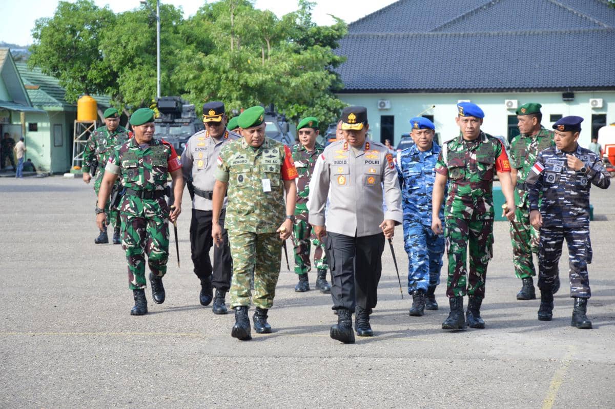 Personel gabungan TNI dan Polri berjalan bersama di area Makorem 161/Wira Sakti Kupang menjelang kedatangan pejabat penting.