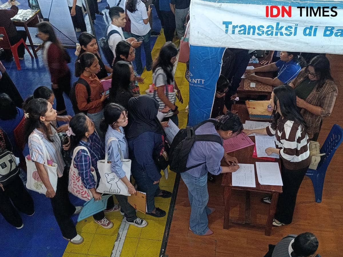 Sejumlah pencari kerja mengantre dan mengisi formulir pendaftaran di stan Job Fair NTT 2026 yang berlangsung di Kupang.