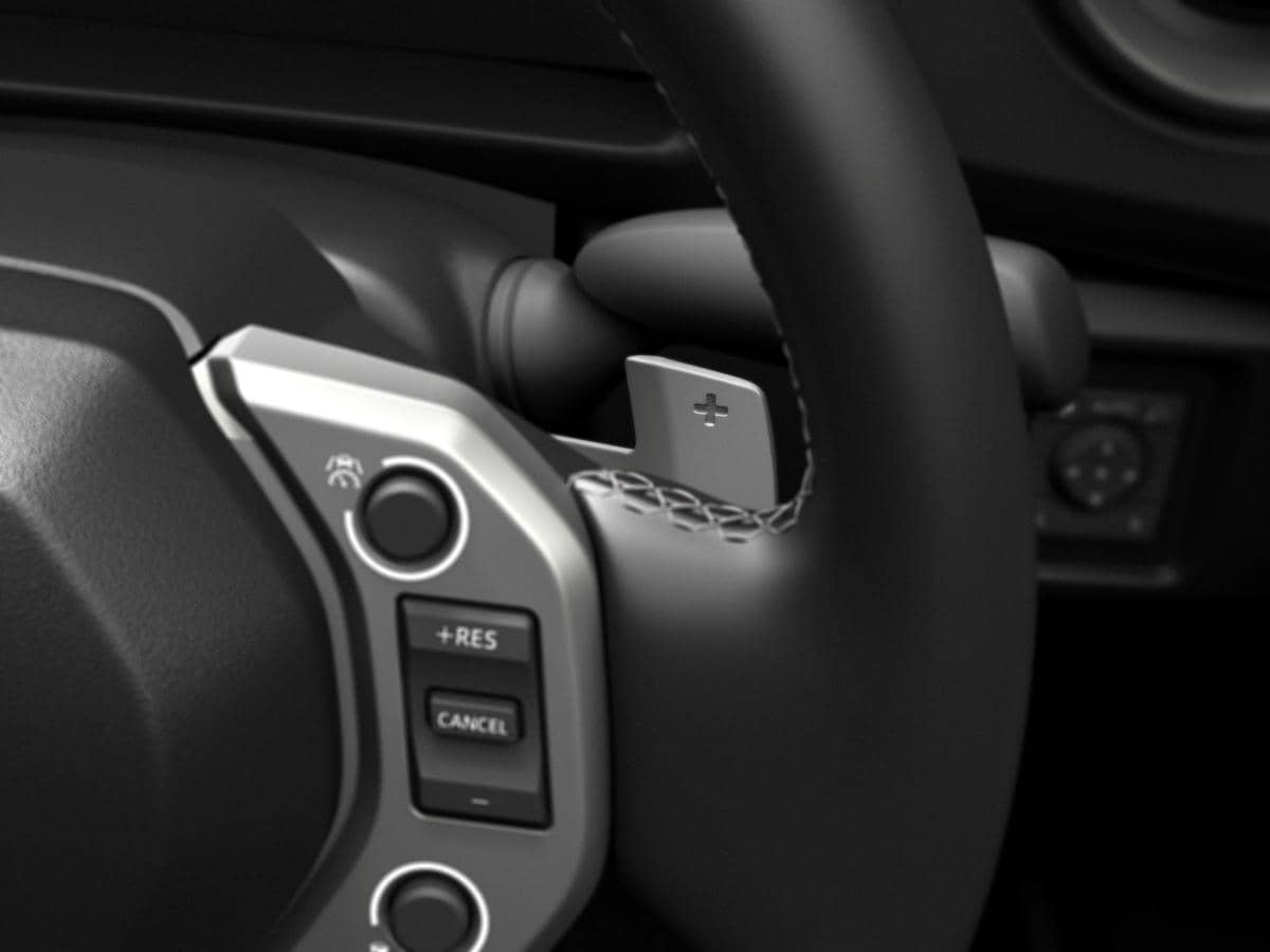 Tampilan detail setir mobil dengan tombol kontrol baru dan paddle shift bertanda plus di bagian belakang kemudi.