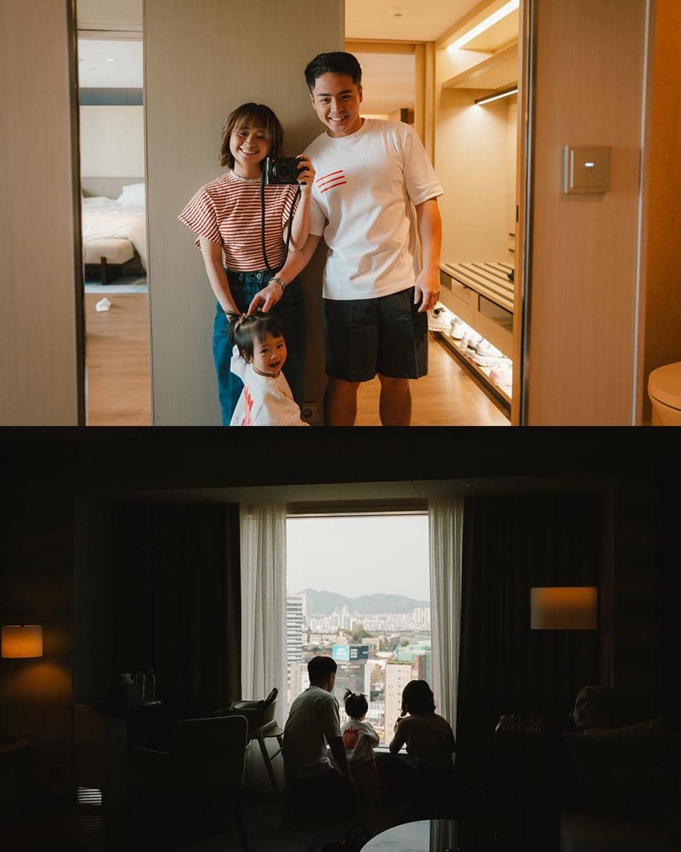 Sebuah keluarga berfoto di depan cermin kamar hotel dan menikmati pemandangan kota dari jendela besar di Gangnam, Seoul.