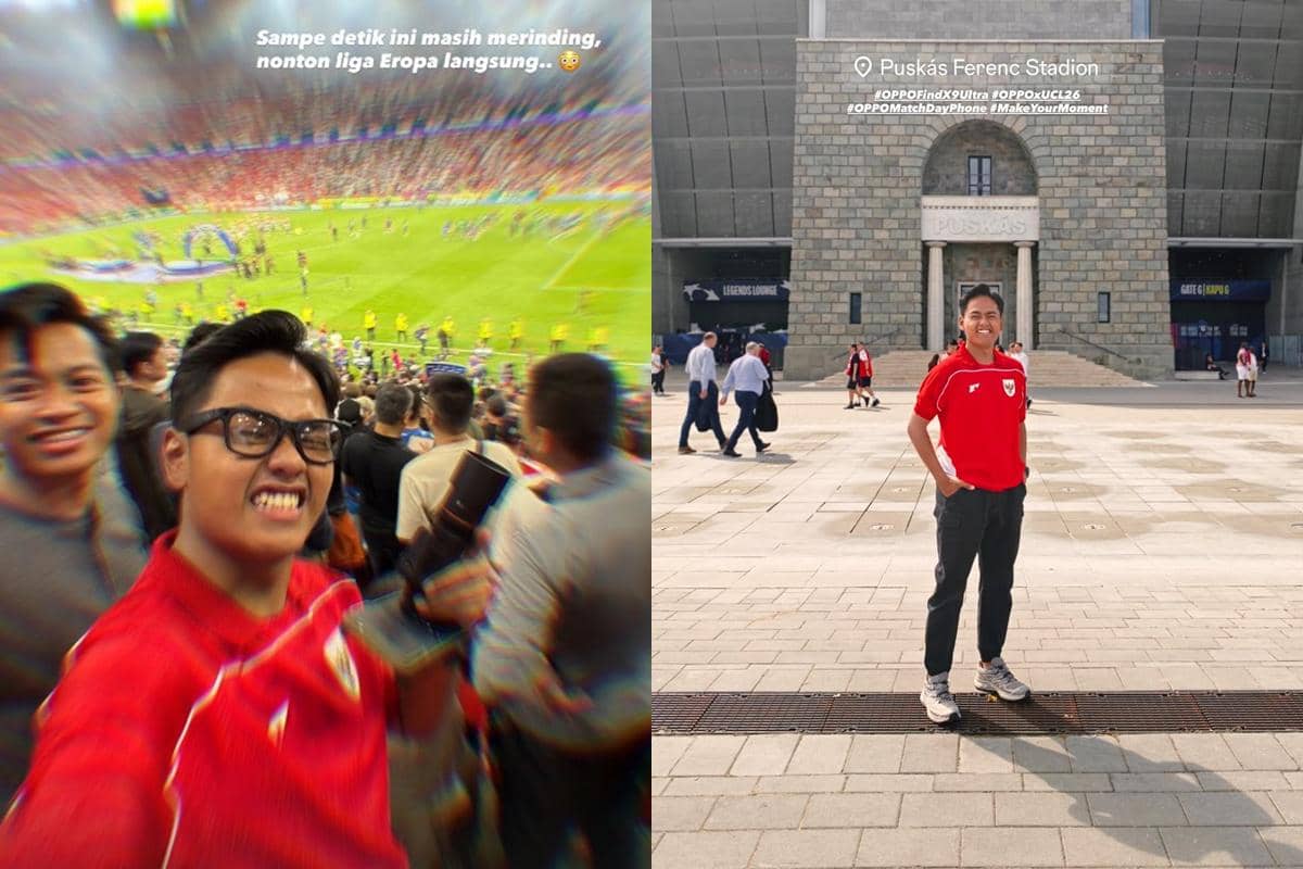 Seorang pria mengenakan jersey merah berfoto di stadion saat menonton final Liga Champions antara Arsenal dan PSG di Puskás Ferenc Stadion.