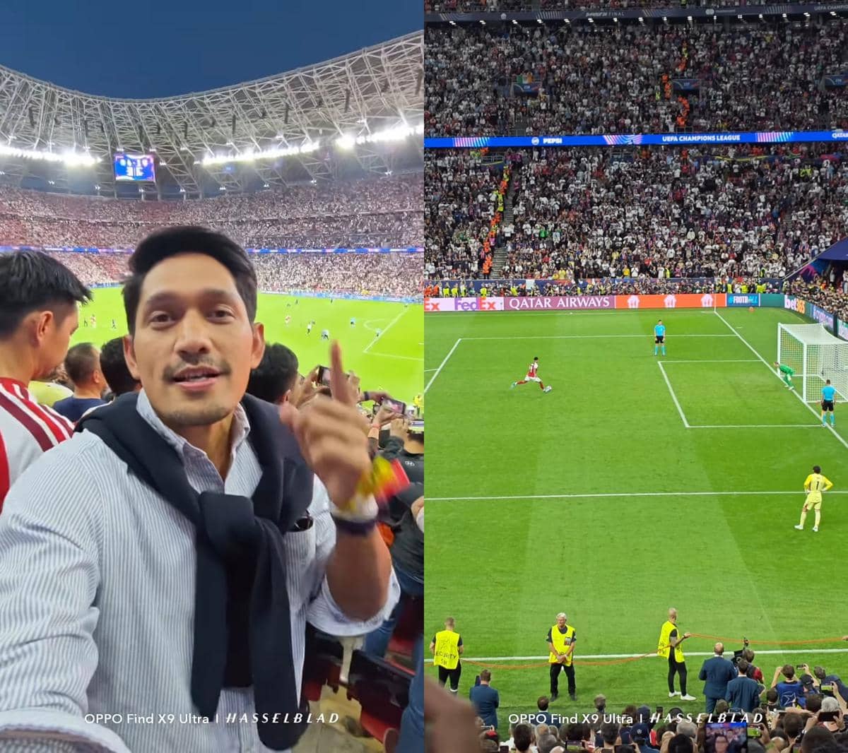 Seorang penonton merekam suasana final Liga Champions antara Arsenal dan PSG di stadion yang penuh sesak dengan sorak penonton.
