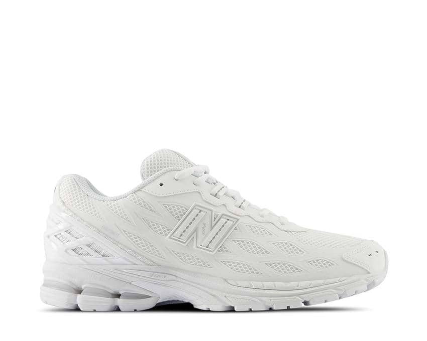 Sepatu olahraga New Balance 1960F berwarna putih dengan desain jaring dan sol tebal untuk kenyamanan dan performa maksimal.