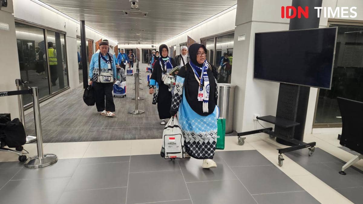 Sejumlah jemaah haji mengenakan seragam biru hitam tiba di Bandara Soekarno-Hatta sambil membawa tas dan perlengkapan haji.
