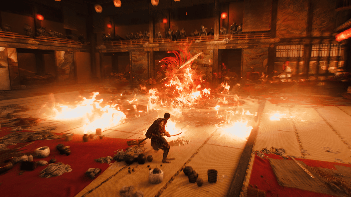 Seorang samurai menghadapi makhluk api besar di tengah ruangan tradisional Jepang yang terbakar dalam adegan permainan Onimusha: Way of the Sword.