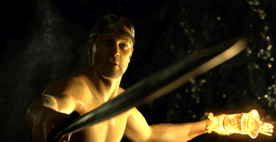 Seorang pria berotot memegang pedang besar dan perisai bercahaya dalam adegan film animasi Beowulf tahun 2007.
