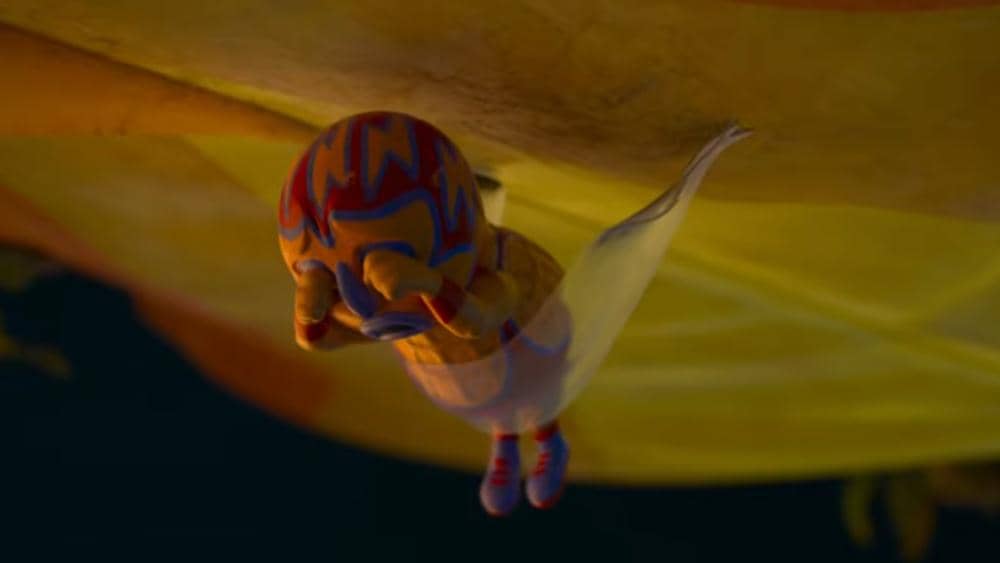 Karakter mainan berwarna merah, biru, dan kuning melompat dengan kain seperti parasut dalam cuplikan film animasi Toy Story 5.