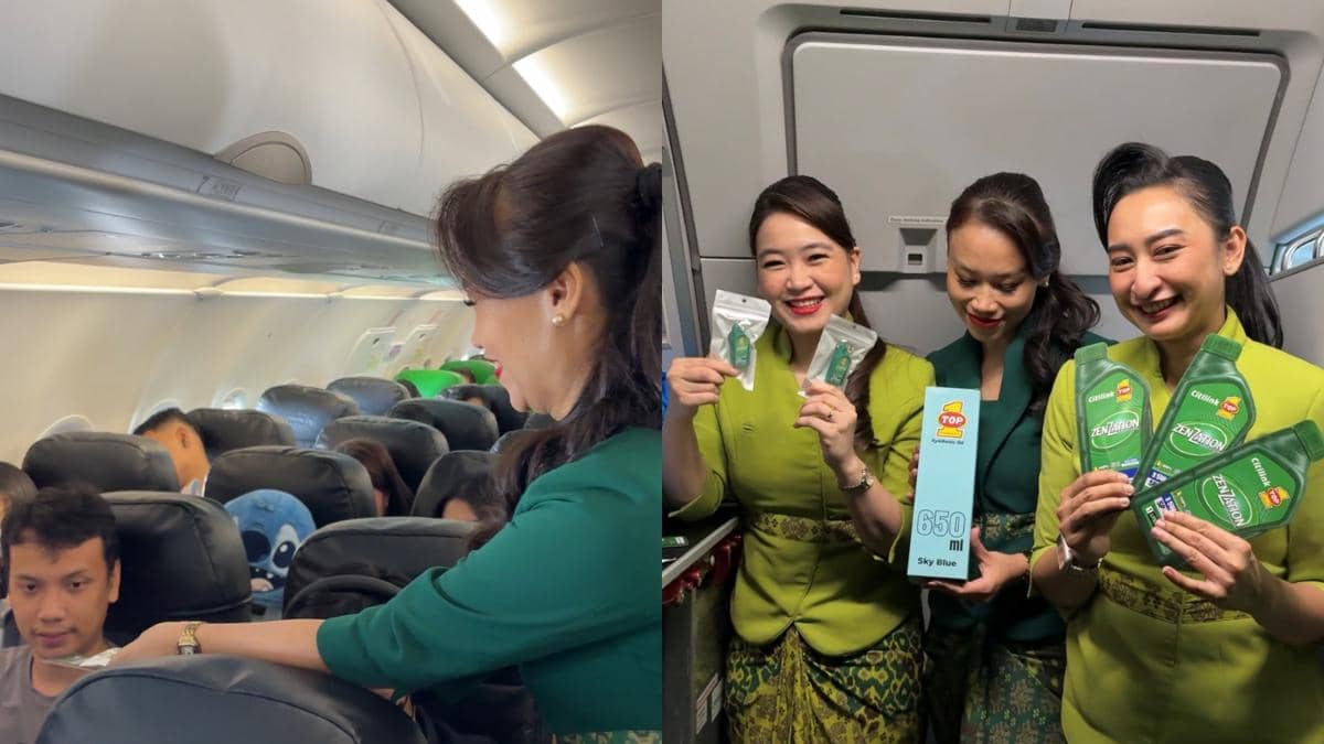 Pramugari Citilink membagikan produk kolaborasi dengan TOP 1 kepada penumpang di dalam kabin pesawat dan berpose sambil memegang produk tersebut.