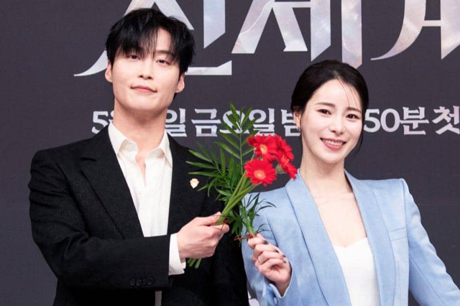 Dua pemeran drama Korea My Royal Nemesis berpose bersama sambil memegang bunga merah di acara promosi serial tersebut.
