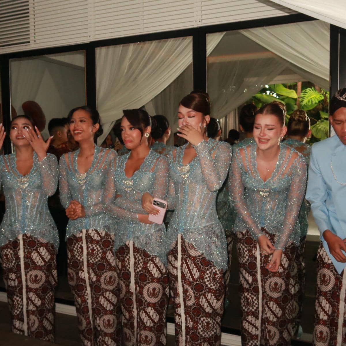 Para bridesmaid mengenakan kebaya biru muda berhias payet dan kain batik cokelat saat menghadiri acara akad pernikahan.