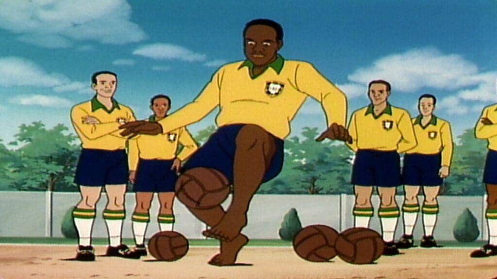 Karakter animasi pemain sepak bola mengenakan seragam kuning dan biru sedang menggiring bola di depan rekan satu timnya di lapangan.