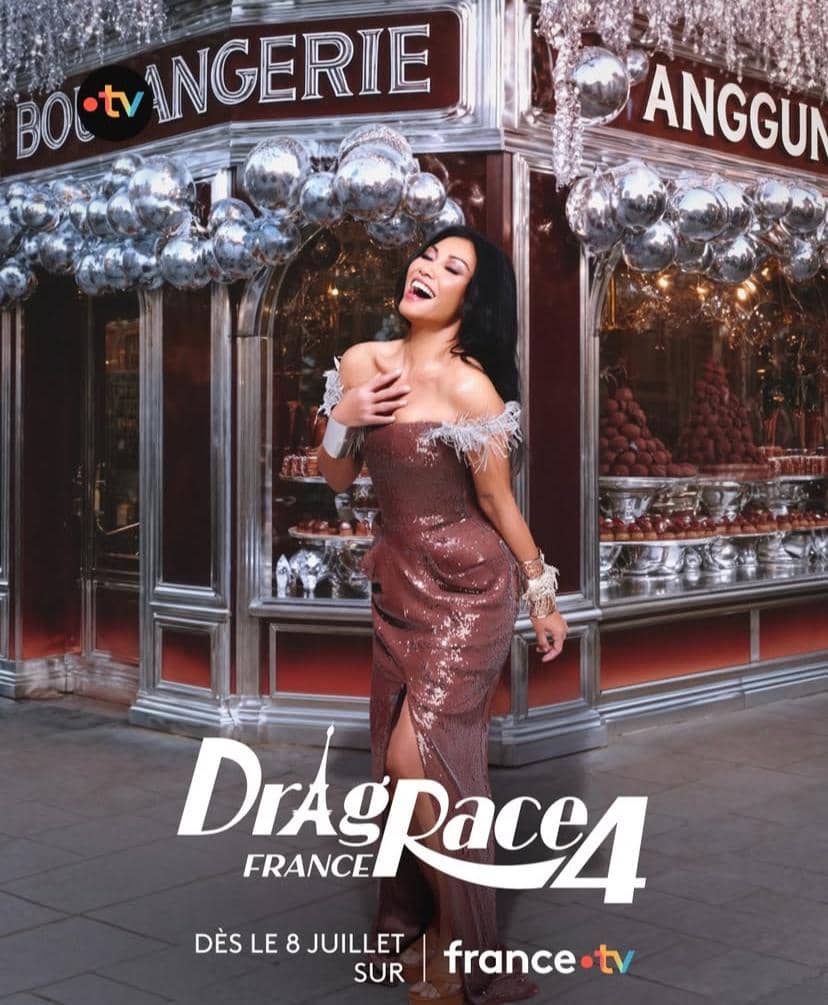Seorang individu bergaun glamor berpose di depan toko bergaya Prancis dengan dekorasi perak dan tulisan Drag Race France 4.