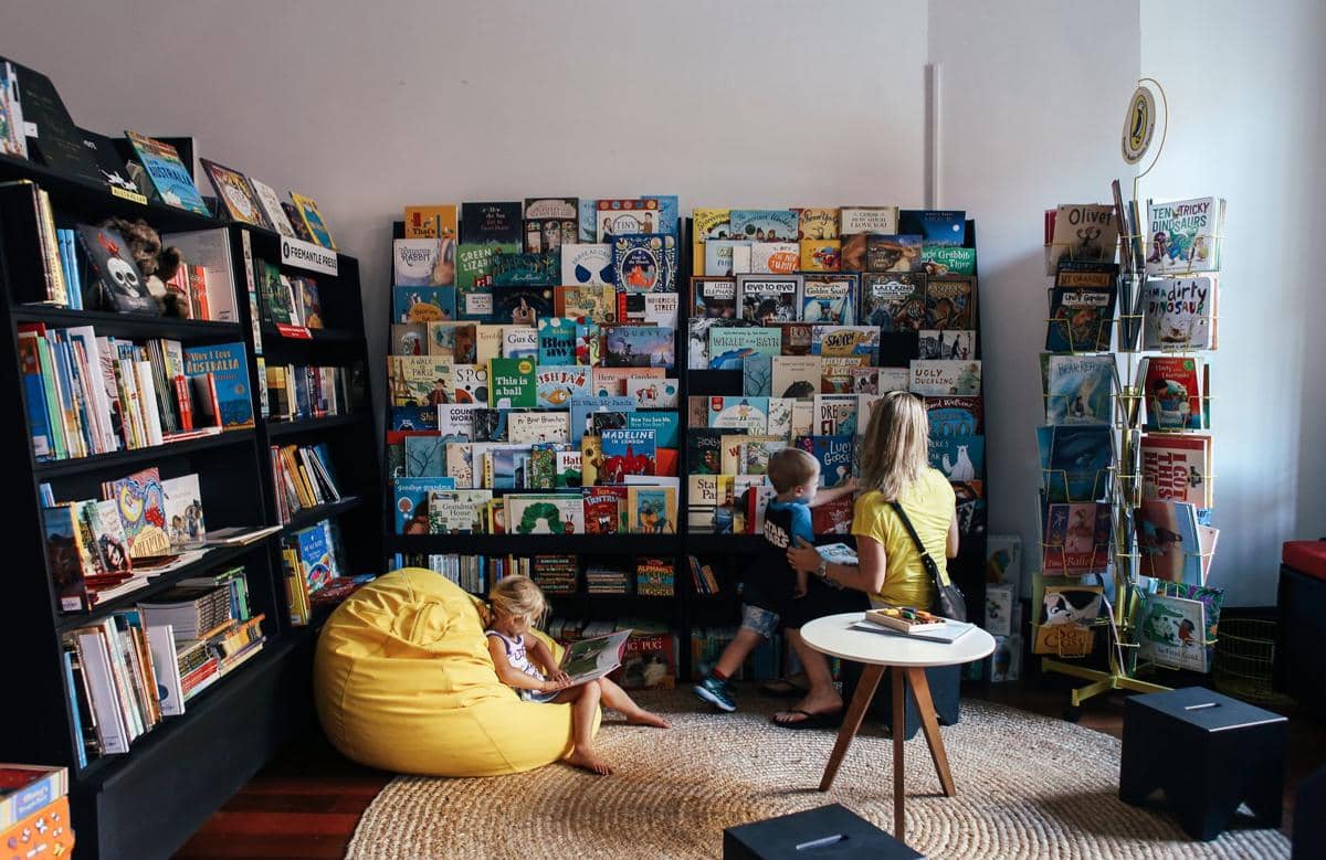 ilustrasi seorang ibu bersama anak-anak di perpustakaan
