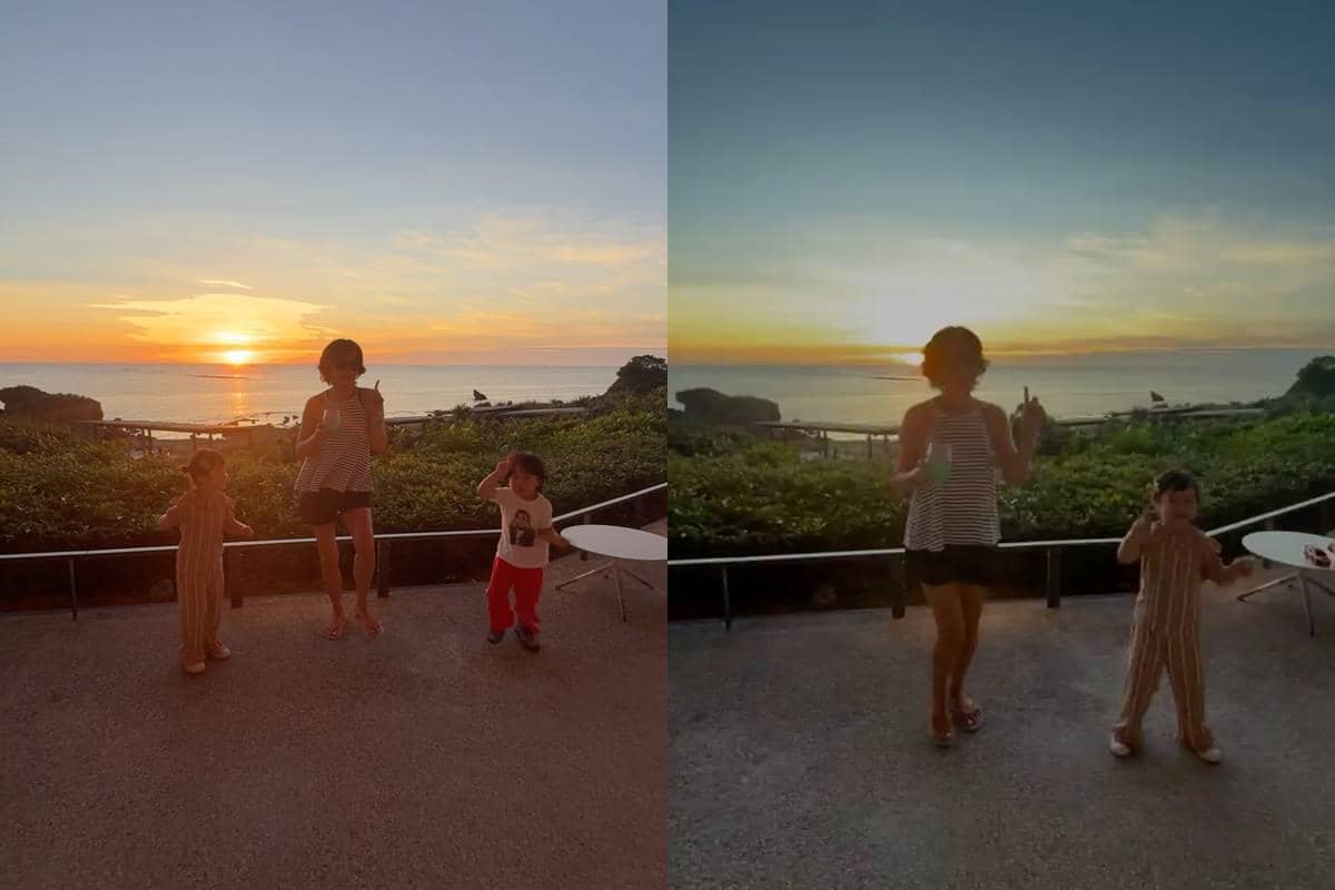Seorang wanita dan dua anak kecil menikmati suasana matahari terbenam di tepi pantai dengan latar langit oranye yang indah.
