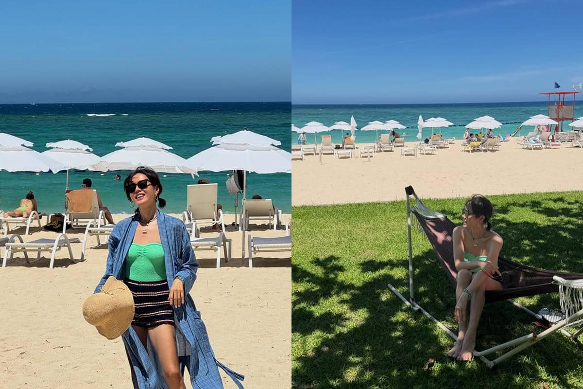 Seorang perempuan menikmati liburan di pantai berpasir putih dengan laut biru, duduk di hammock dan berjalan di bawah payung pantai putih.