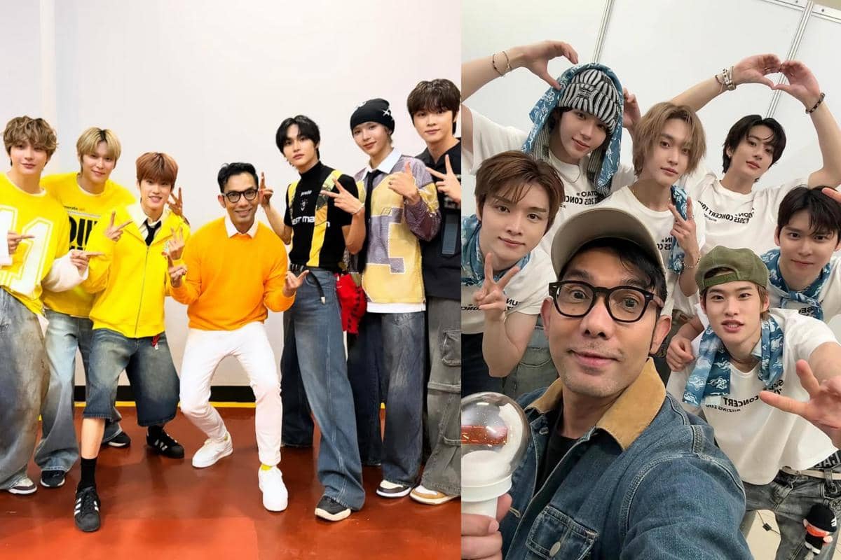 Seorang pria berpose bersama grup musik pria asal Korea Selatan, mengenakan pakaian kasual berwarna cerah dan tersenyum ke kamera.
