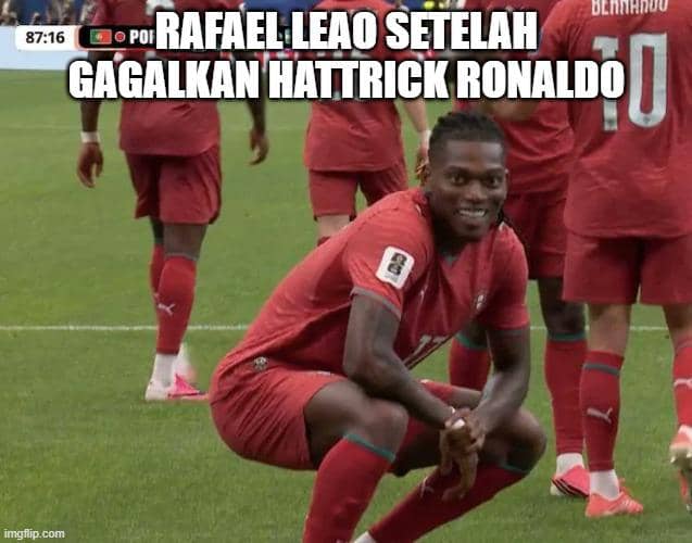 Pemain tim nasional Portugal berpose sambil tersenyum di lapangan dengan rekan setimnya di latar belakang mengenakan seragam merah.