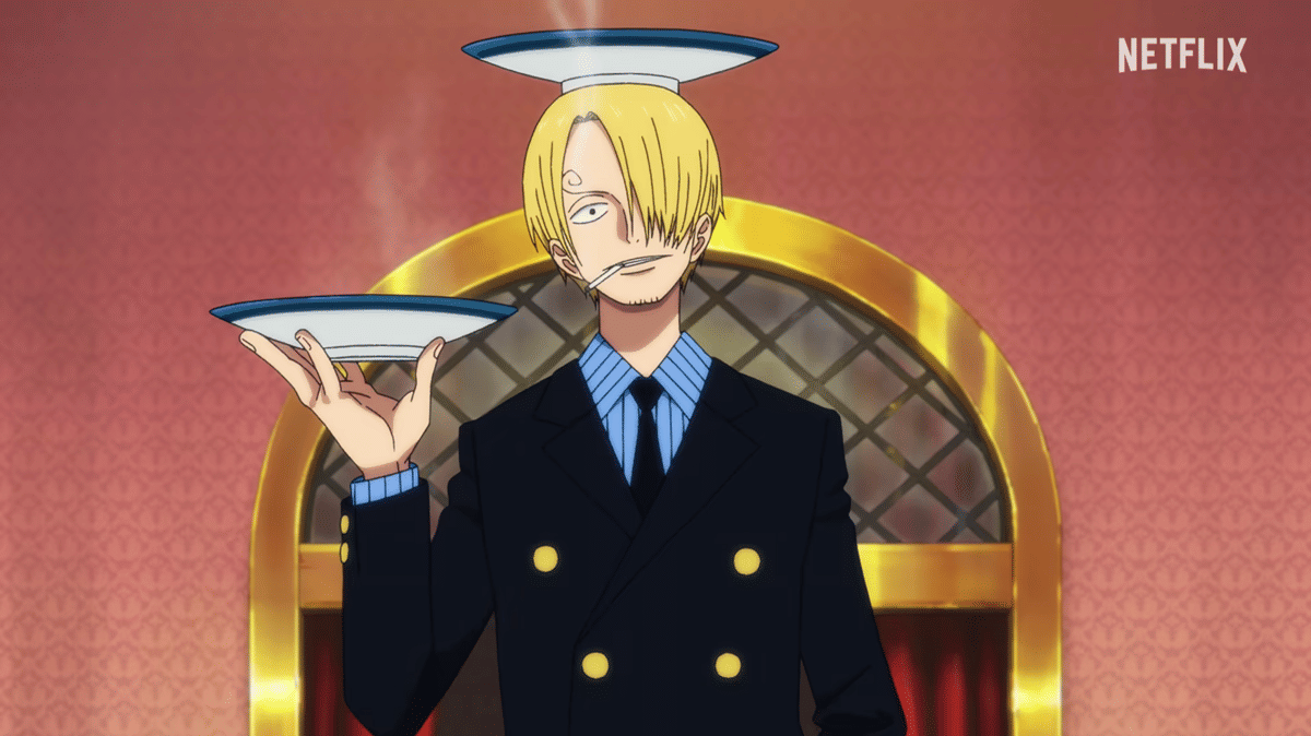Sanji mengenakan setelan jas hitam dengan dasi biru, memegang piring di tangannya dan menyeimbangkan satu piring di atas kepalanya.