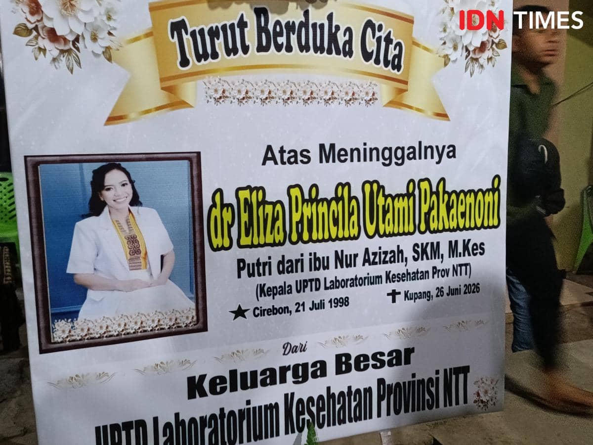 Karangan bunga duka cita untuk dr. Eliza Princila Utami Pakaenoni di rumah duka dengan foto almarhumah dan ucapan belasungkawa.