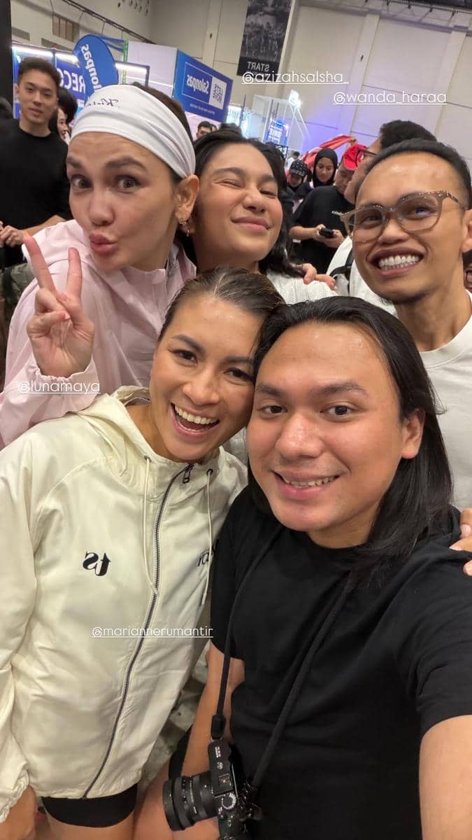 Sekelompok orang tersenyum dan berpose bersama di acara HYROX Jakarta 2026 Day 2 dengan suasana ramai di latar belakang.