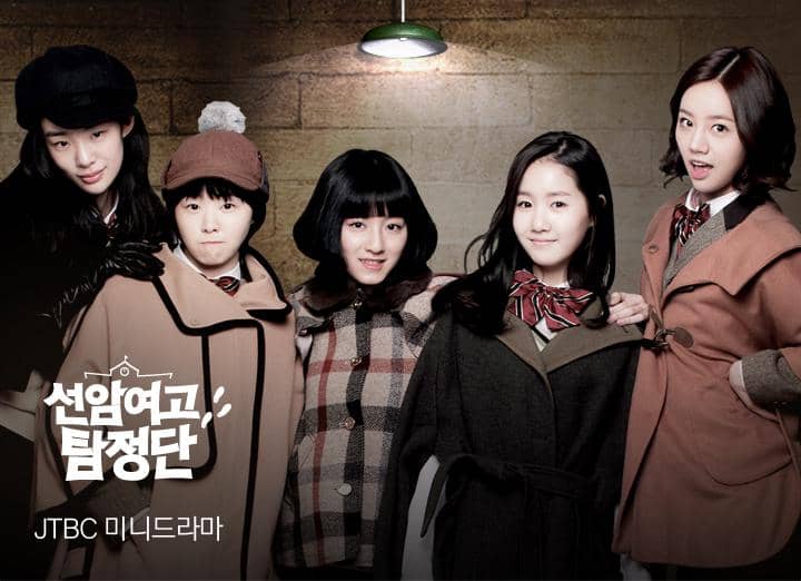 Lima siswi mengenakan seragam sekolah musim dingin berpose bersama di depan dinding bata untuk poster drama Schoolgirl Detectives.