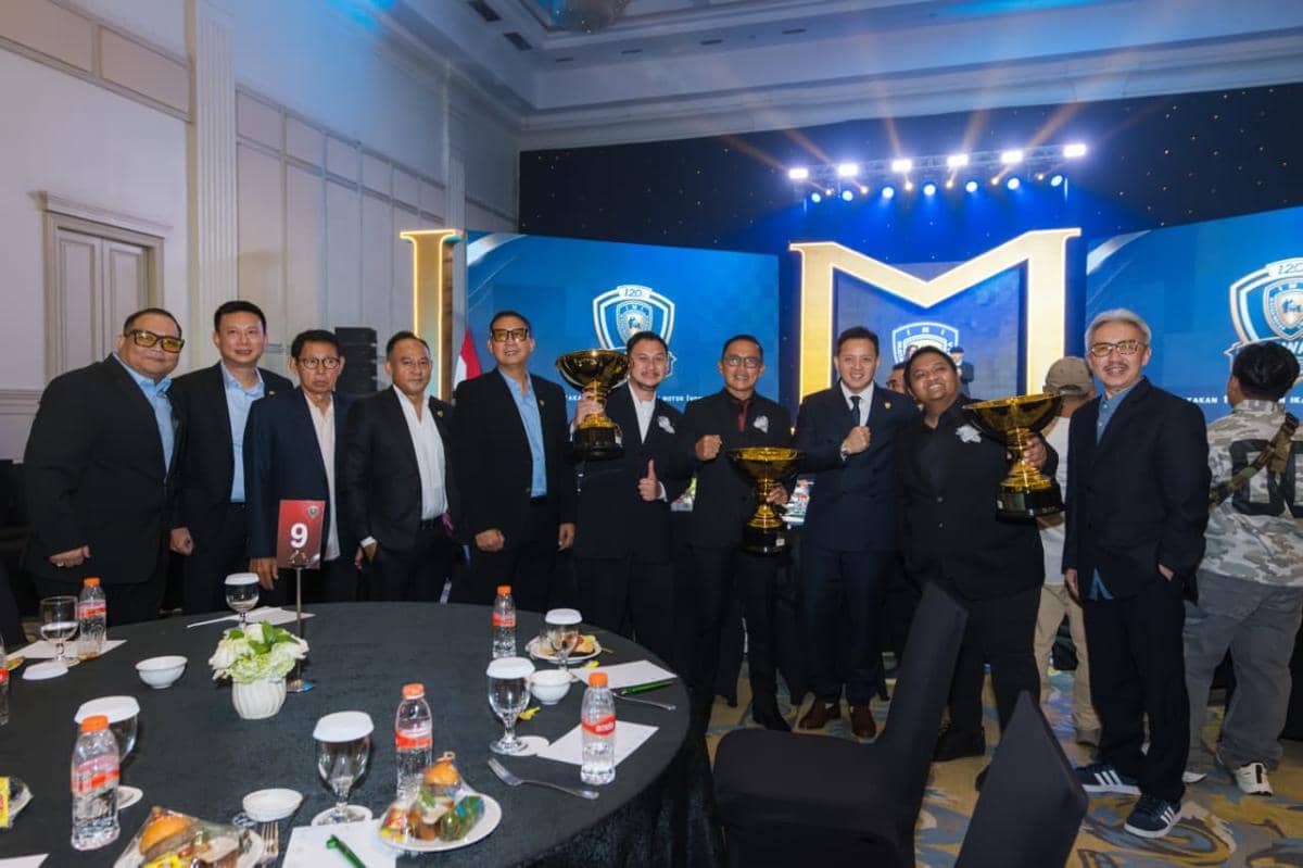 Sejumlah pria berpakaian formal berpose bersama di acara penghargaan IMI, tiga di antaranya memegang piala besar berwarna emas.