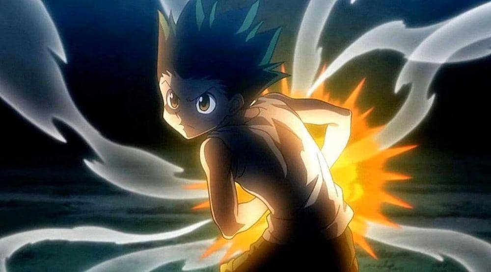 Gon Freecss bersiap melancarkan serangan Jajanken: Rock dengan aura energi menyala di sekeliling tubuhnya di latar gelap.