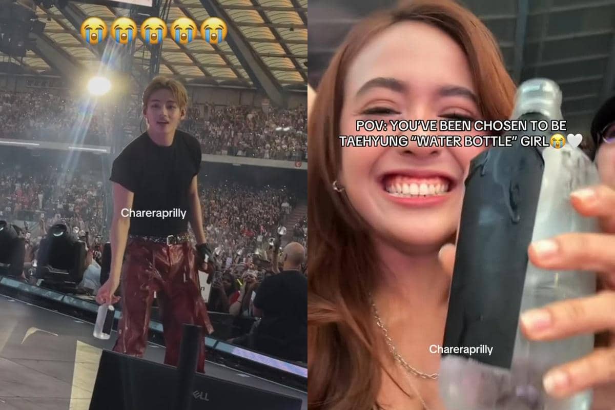 Seorang penyanyi di atas panggung konser besar menyerahkan botol air kepada penonton, sementara seorang wanita tersenyum lebar sambil memegang botol tersebut.