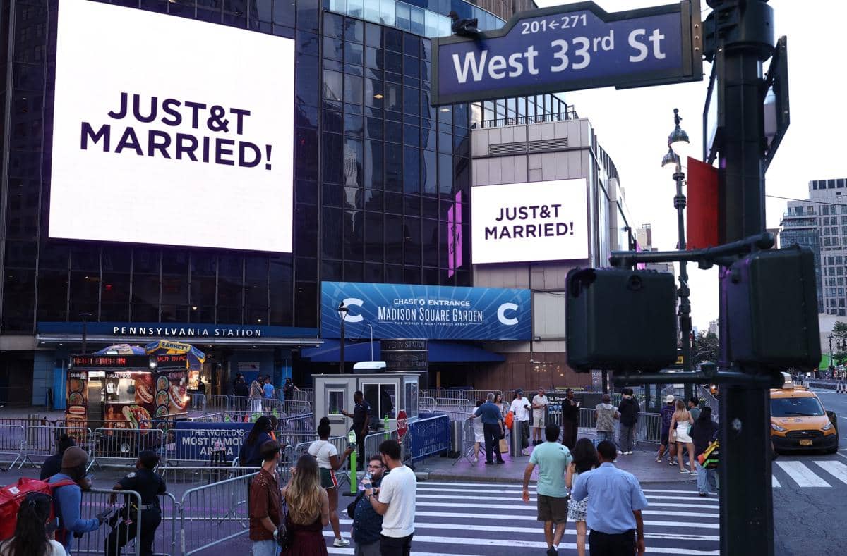 Layar besar di dekat Madison Square Garden menampilkan tulisan JUST&T MARRIED di atas jalan West 33rd Street, New York.