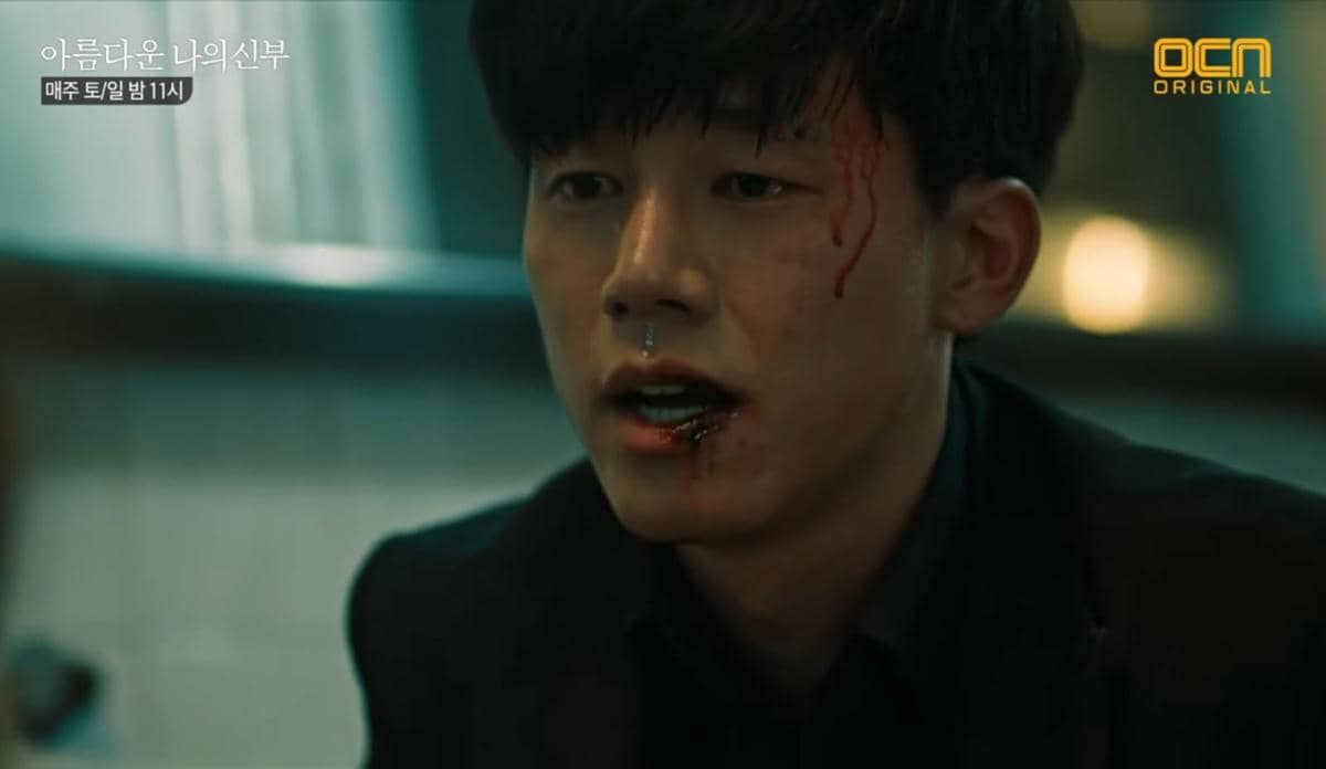 Seorang pria dengan wajah berdarah dan luka di bibir tampak lemah dalam adegan tegang dari drama My Beautiful Bride.