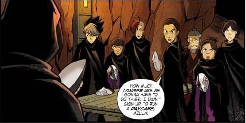Azula berdiri bersama kelompok Fire Warriors di dalam gua, mengenakan jubah hitam sambil memegang topeng putih dalam adegan komik.